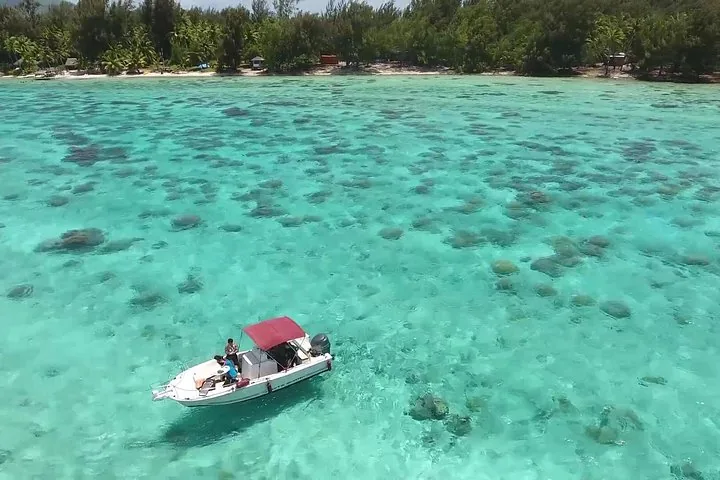 Small boat over coral patches