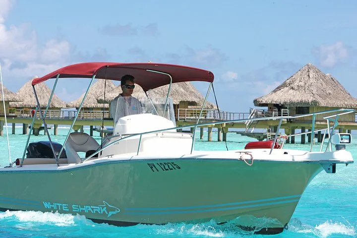 White Shark boat moored by overwater bungalows