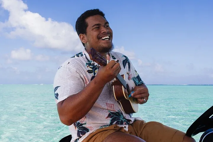 Guide playing the ukulele on the boat