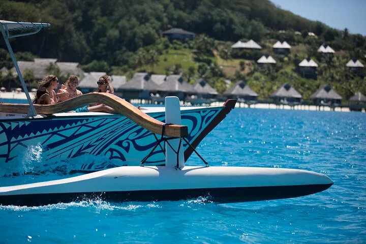 Lagoon Service boat cruising past overwater bungalows