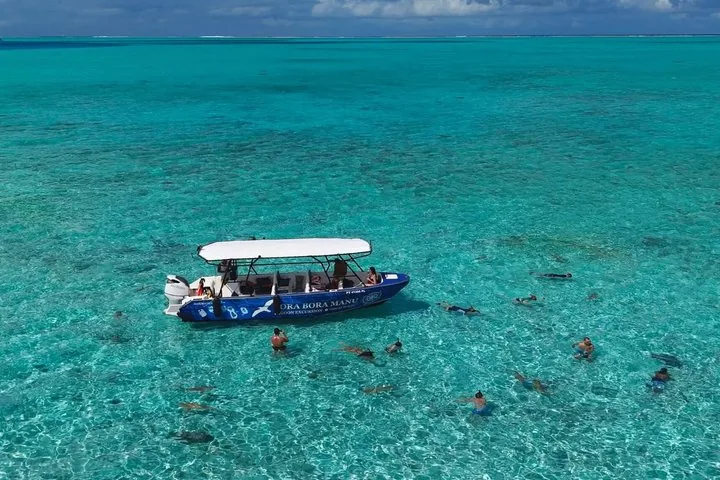 Boat anchored over coral in turquoise water