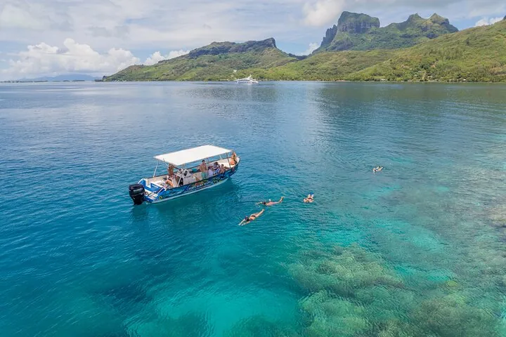 Boat on calm water with the island's peaks behind