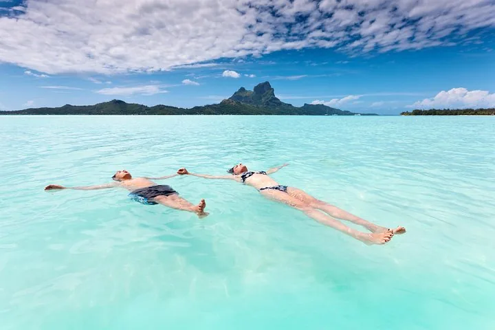 Two snorkellers floating in pale shallow water