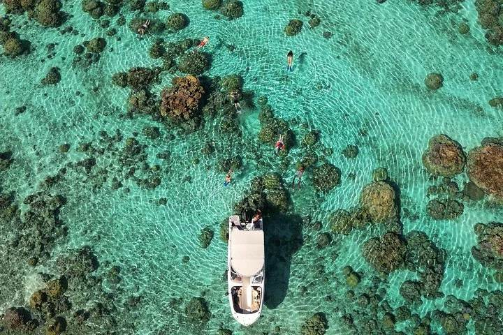 Boat seen from above over coral patches