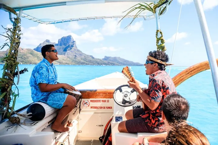 Guide steering the boat with Mount Otemanu behind
